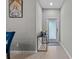 Inviting foyer with neutral walls, modern console table and tiled flooring for a minimalist appeal at 9009 Savannah Julip Ln, Orlando, FL 32832