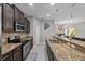Modern kitchen features granite countertops, stainless steel appliances, and dark cabinetry at 9009 Savannah Julip Ln, Orlando, FL 32832