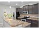 Well-equipped kitchen with granite countertops, stainless appliances, and ample cabinet space at 9009 Savannah Julip Ln, Orlando, FL 32832