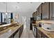 Charming kitchen with granite counters, dark cabinets, stainless steel appliances, and modern fixtures at 9009 Savannah Julip Ln, Orlando, FL 32832