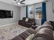 Comfortable living room with plush seating and a large TV at 9009 Savannah Julip Ln, Orlando, FL 32832
