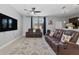 Comfortable living room featuring a ceiling fan, large couches, patterned rug, and ample natural light at 9009 Savannah Julip Ln, Orlando, FL 32832