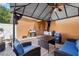 Inviting covered patio features brick pavers, comfortable seating, and a grill, perfect for outdoor living and entertaining at 9009 Savannah Julip Ln, Orlando, FL 32832