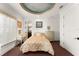 A cozy bedroom featuring neutral tones, recessed lighting, and a luxurious domed ceiling at 9730 Lounsberry Cir, Golden Oak, FL 32836