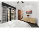 Bright bedroom with white bedding, dark carpet, and outdoor views and a TV mounted to the wall at 9730 Lounsberry Cir, Golden Oak, FL 32836