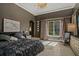 Comfortable primary bedroom showcasing a large window and decorative chandelier at 9730 Lounsberry Cir, Golden Oak, FL 32836