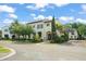 Inviting two-story home featuring a tile roof, stucco exterior, and well-manicured landscaping at 9730 Lounsberry Cir, Golden Oak, FL 32836