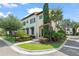 Elegant two-story home boasts lush landscaping and a charming facade with green awnings at 9730 Lounsberry Cir, Golden Oak, FL 32836