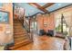 Grand foyer featuring a wood staircase, tile flooring, and decorative accents for a welcoming entry at 9730 Lounsberry Cir, Golden Oak, FL 32836