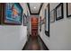 Hallway with hardwood floors and artwork leading to a custom closet at 9730 Lounsberry Cir, Golden Oak, FL 32836