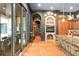 Elegant kitchen with terracotta tile floors, fireplace, and an island with seating at 9730 Lounsberry Cir, Golden Oak, FL 32836