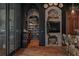 Stylish kitchen with a brick fireplace, wine rack, and decorative elements at 9730 Lounsberry Cir, Golden Oak, FL 32836