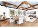 Open concept living area featuring living room, dining room and wood beam ceiling at 9730 Lounsberry Cir, Golden Oak, FL 32836