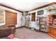 Cozy living room featuring hardwood floors, built-in shelving, and abundant natural light at 9730 Lounsberry Cir, Golden Oak, FL 32836