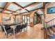 Open living area with exposed beams, tile flooring, and an inviting atmosphere for entertaining at 9730 Lounsberry Cir, Golden Oak, FL 32836