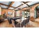 Expansive living area featuring exposed beams, tile floors, and seamless transition to the outdoors at 9730 Lounsberry Cir, Golden Oak, FL 32836