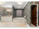 Bathroom with granite countertops, soaking tub, and patterned wallpaper at 9730 Lounsberry Cir, Golden Oak, FL 32836