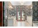 Bathroom with granite countertops, patterned wallpaper, and access to an outdoor pool at 9730 Lounsberry Cir, Golden Oak, FL 32836