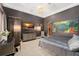 Bedroom with silver furniture, TV, carpet, and elegant lighting at 9730 Lounsberry Cir, Golden Oak, FL 32836