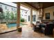 Outdoor kitchen and dining area overlooking the pool with a built-in grill and ample counter space at 9730 Lounsberry Cir, Golden Oak, FL 32836