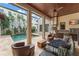 A covered outdoor kitchen provides a perfect transition to enjoy the pool and manicured garden at 9730 Lounsberry Cir, Golden Oak, FL 32836