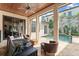 Relaxing outdoor living area with a pool view from covered patio and wood ceiling at 9730 Lounsberry Cir, Golden Oak, FL 32836