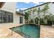Picturesque backyard featuring a tranquil pool surrounded by manicured landscaping and Mediterranean-style architecture at 9730 Lounsberry Cir, Golden Oak, FL 32836