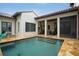 Stunning pool area with stone decking, lush landscaping, and direct access to the home's indoor/outdoor living spaces at 9730 Lounsberry Cir, Golden Oak, FL 32836