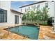 Inviting pool surrounded by lush landscaping and a travertine deck, perfect for outdoor relaxation at 9730 Lounsberry Cir, Golden Oak, FL 32836