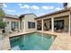 A serene outdoor pool and patio area with an outdoor kitchen and seating, blending relaxation and entertainment at 9730 Lounsberry Cir, Golden Oak, FL 32836