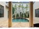Inviting pool area framed by elegant architectural elements and lush, mature landscaping at 9730 Lounsberry Cir, Golden Oak, FL 32836