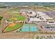 Aerial view of the school complex with athletic fields, tennis courts, and ample parking at 10139 Austrina Oak Loop, Winter Garden, FL 34787