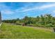 Fenced backyard with a playset and lush grass and forest views at 10139 Austrina Oak Loop, Winter Garden, FL 34787