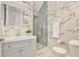 Elegant bathroom featuring marble walls, a glass-enclosed shower, and a modern vanity with designer fixtures at 10139 Austrina Oak Loop, Winter Garden, FL 34787