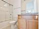Bathroom featuring a shower-tub combo with glass door, tile flooring, and granite vanity at 10139 Austrina Oak Loop, Winter Garden, FL 34787