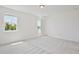 Expansive room with bright carpet, natural light from two windows, and ensuite access at 10139 Austrina Oak Loop, Winter Garden, FL 34787