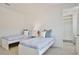 Bright bedroom with two twin beds, window views, and closet space at 10139 Austrina Oak Loop, Winter Garden, FL 34787