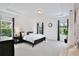 Spacious bedroom featuring a tray ceiling, carpet, and large windows at 10139 Austrina Oak Loop, Winter Garden, FL 34787