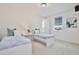 Bright bedroom with two twin beds, window views, and stylish decor at 10139 Austrina Oak Loop, Winter Garden, FL 34787