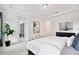 Bright bedroom with tray ceilings, large window and white linens at 10139 Austrina Oak Loop, Winter Garden, FL 34787