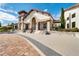Beautiful clubhouse exterior featuring stone accents, arched entryway, and lush landscaping at 10139 Austrina Oak Loop, Winter Garden, FL 34787