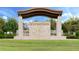Community entrance with stone signage, covered entry and manicured landscaping at 10139 Austrina Oak Loop, Winter Garden, FL 34787