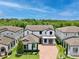 Aerial view of a two-story home with a brick driveway at 10139 Austrina Oak Loop, Winter Garden, FL 34787