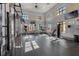 Well-equipped fitness center with modern exercise machines, multiple windows, and TVs at 10139 Austrina Oak Loop, Winter Garden, FL 34787