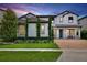 Beautiful two-story home with a brick driveway, manicured lawn, and vibrant landscaping offering excellent curb appeal at 10139 Austrina Oak Loop, Winter Garden, FL 34787