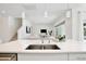 Bright, open kitchen featuring white cabinets, island with seating, and a view to the living room at 10139 Austrina Oak Loop, Winter Garden, FL 34787