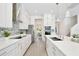 Bright, open kitchen featuring white cabinets, stainless steel appliances, and a view to the dining room at 10139 Austrina Oak Loop, Winter Garden, FL 34787