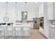 Modern kitchen featuring white cabinets, an island with seating, and stainless steel appliances at 10139 Austrina Oak Loop, Winter Garden, FL 34787