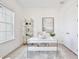 Bright home office with a sleek white desk, modern shelving, and ample natural light, ideal for productivity at 10139 Austrina Oak Loop, Winter Garden, FL 34787