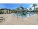 Community splash pool area with a waterslide, lounge seating and a covered pergola at 10139 Austrina Oak Loop, Winter Garden, FL 34787